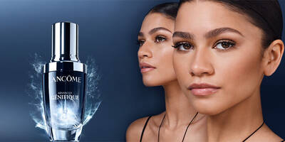 Lancome Advanced Genifique serum bottle with a woman's face in the background