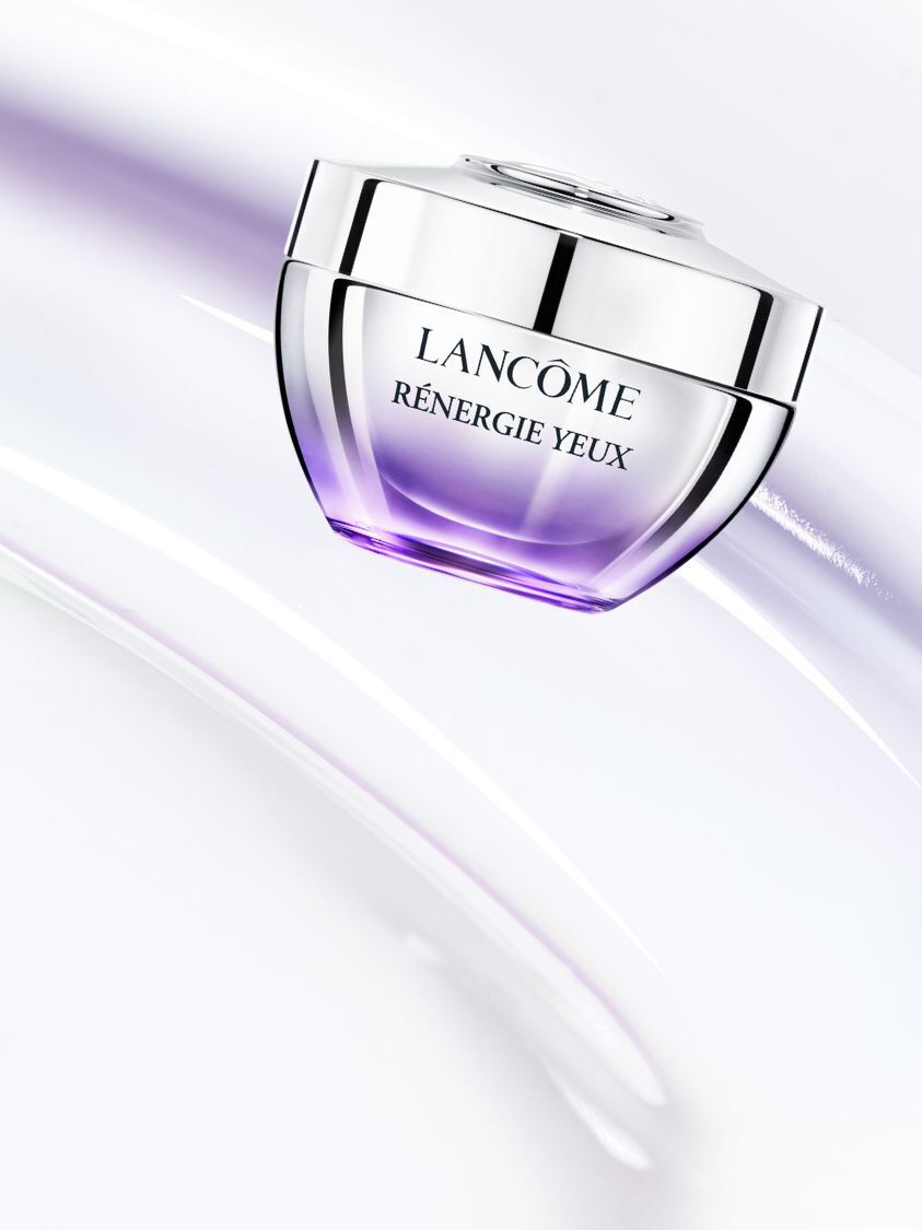 Lancome Renergie Yeux Eye Cream jar on a soft, swirling background.