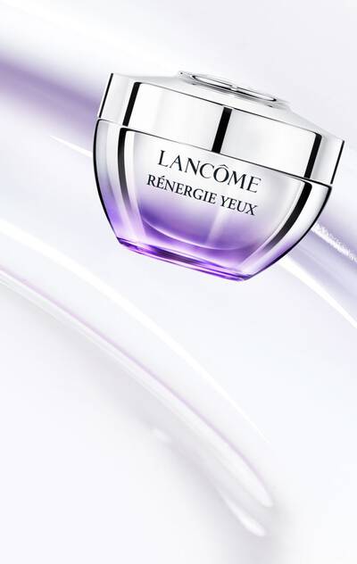 Lancome Renergie Yeux Eye Cream jar on a soft, swirling background.