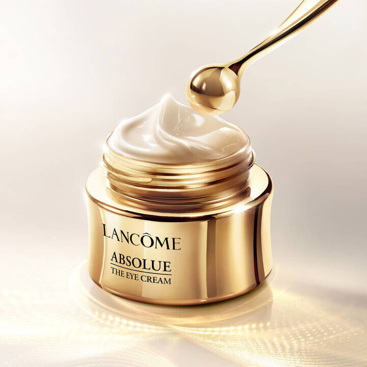 Lancome Absolue The Eye Cream jar with a golden eye cream applicator