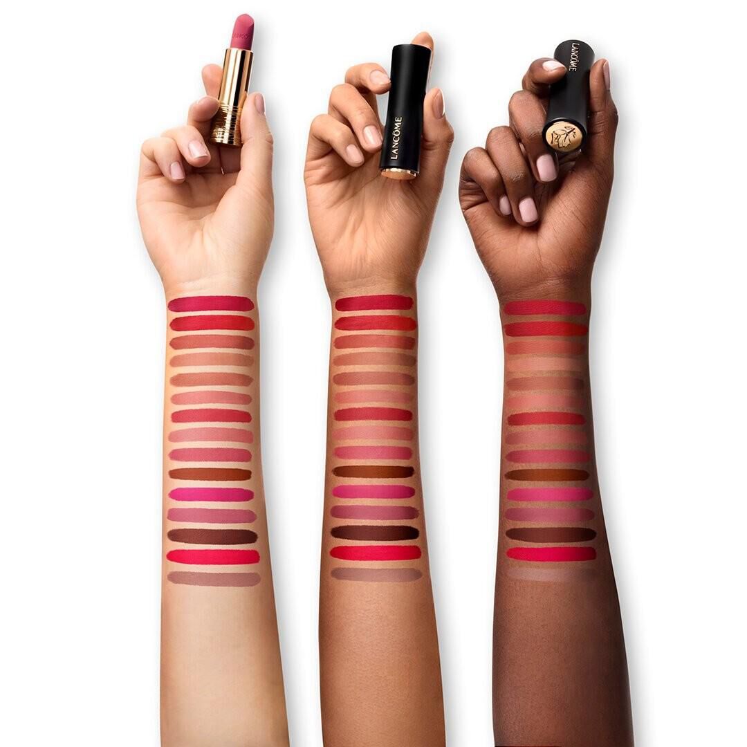 Lancome L'Absolu Rouge Drama Matte lipstick swatches on light, medium, and deep skin tones, displaying a range of red, pink, and nude shades