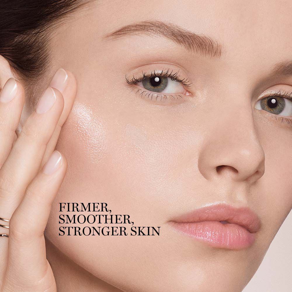 Close-up of a model applying Lancome Absolue Rose 80 Essence-In-Lotion on face