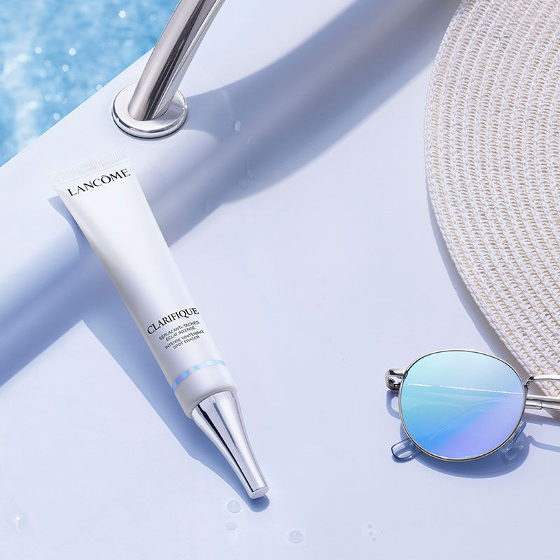 Lancome Clarifique Spot Eraser placed poolside for sun-related dark spot correction