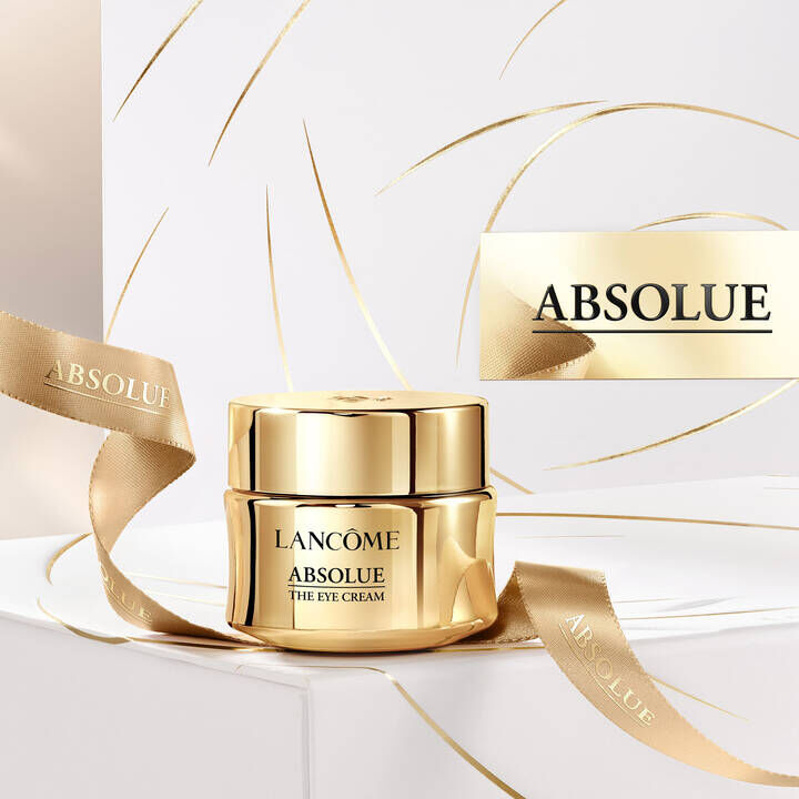 Lancome Absolue The Eye Cream jar with a golden applicator, highlighting the product's luxurious packaging