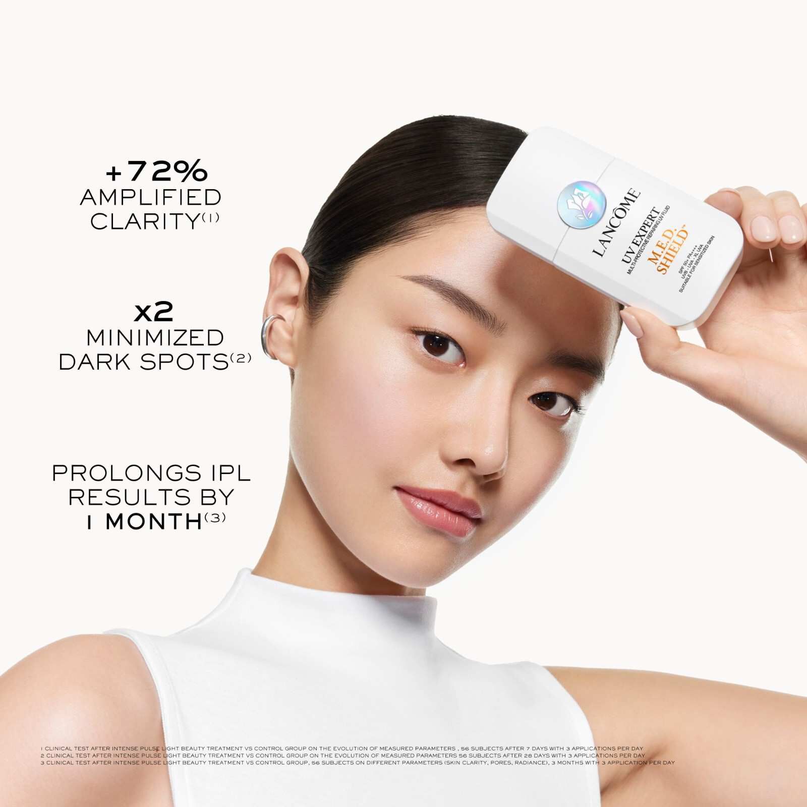 MODEL HOLDING THE PACKSHOT OF UV EXPERT M.E.D. SHIELD SPF 50+