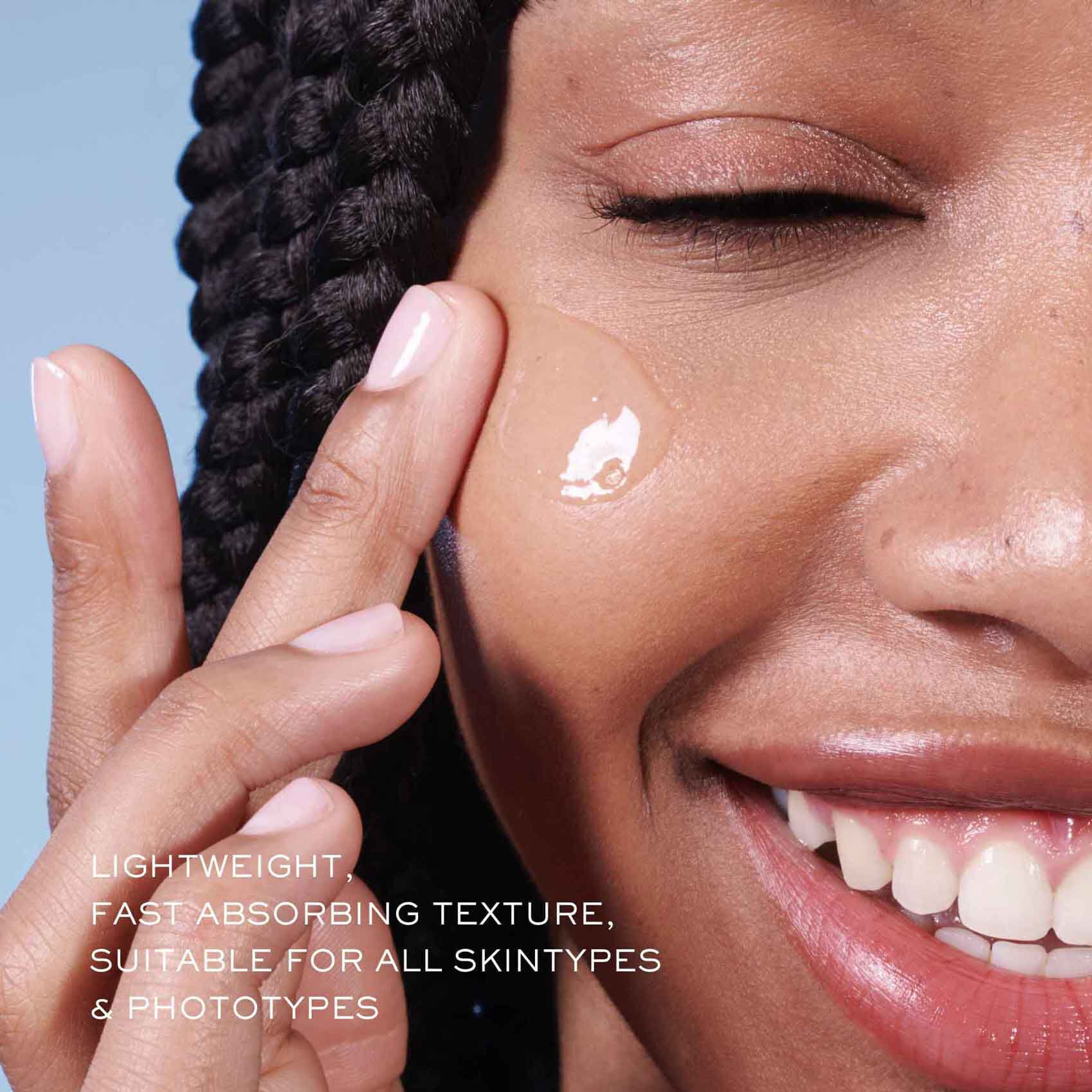 Close-up of model applying Lancome Advanced Genifique serum with text highlighting its lightweight, fast-absorbing texture suitable for all skin types.