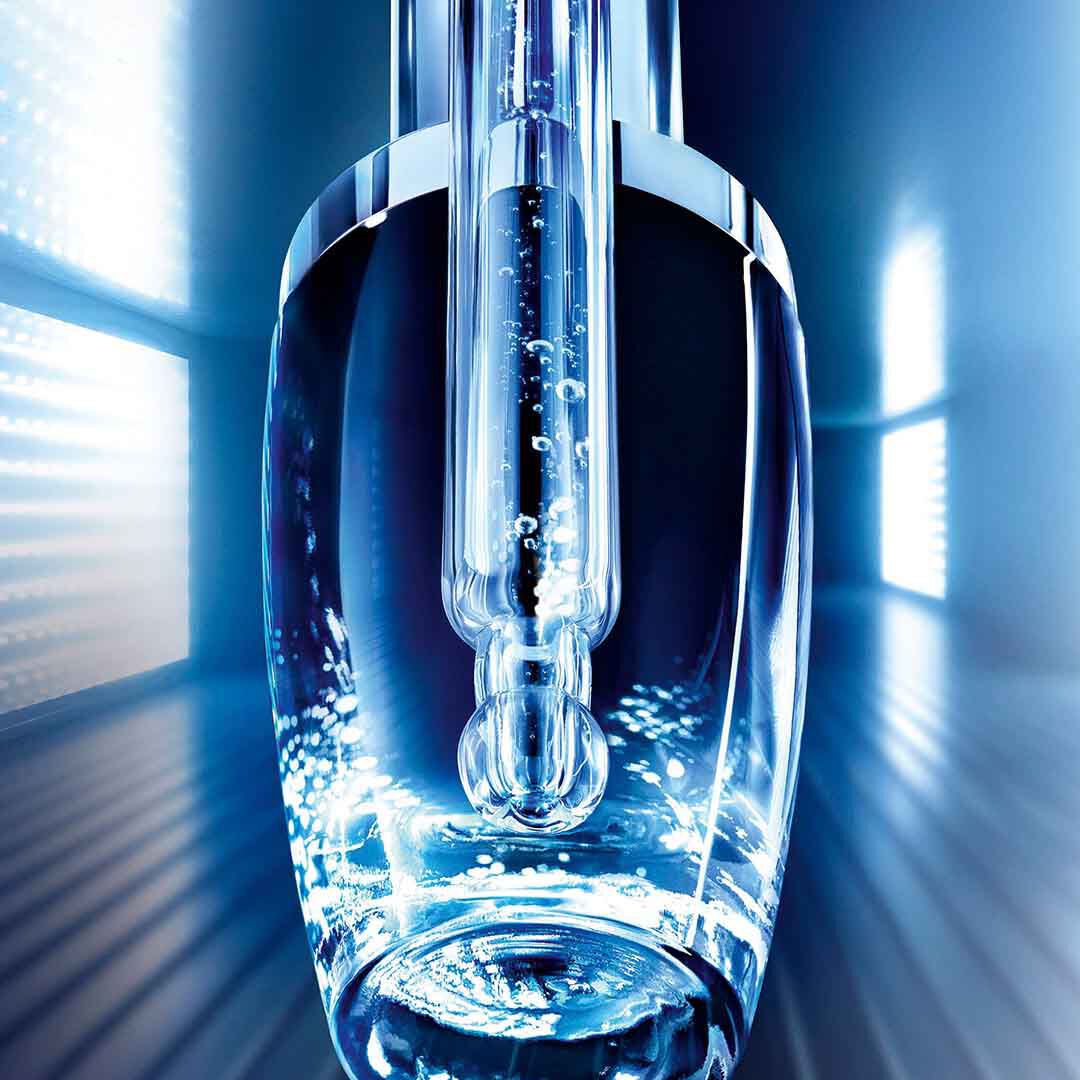 Lancome Advanced Genifique bottle in a modern, illuminated setting, symbolizing advanced skincare technology.
